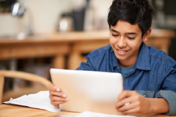Teenage boy looking at ipad