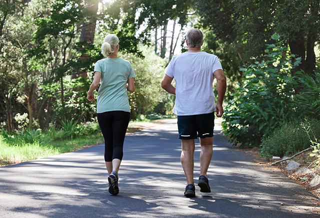 Man and woman walking on a paved trail